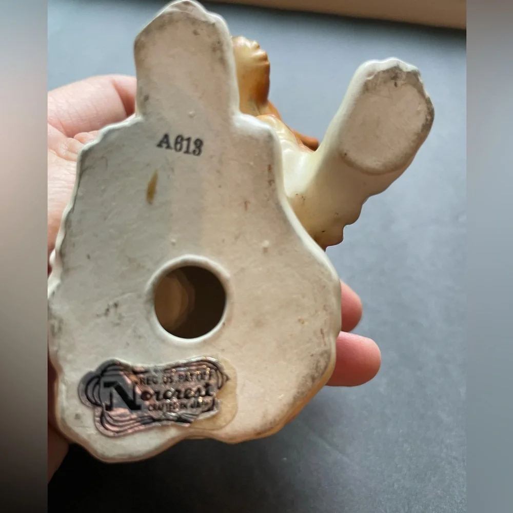 Vintage grumpy anthropomorphic brown dog figurine.